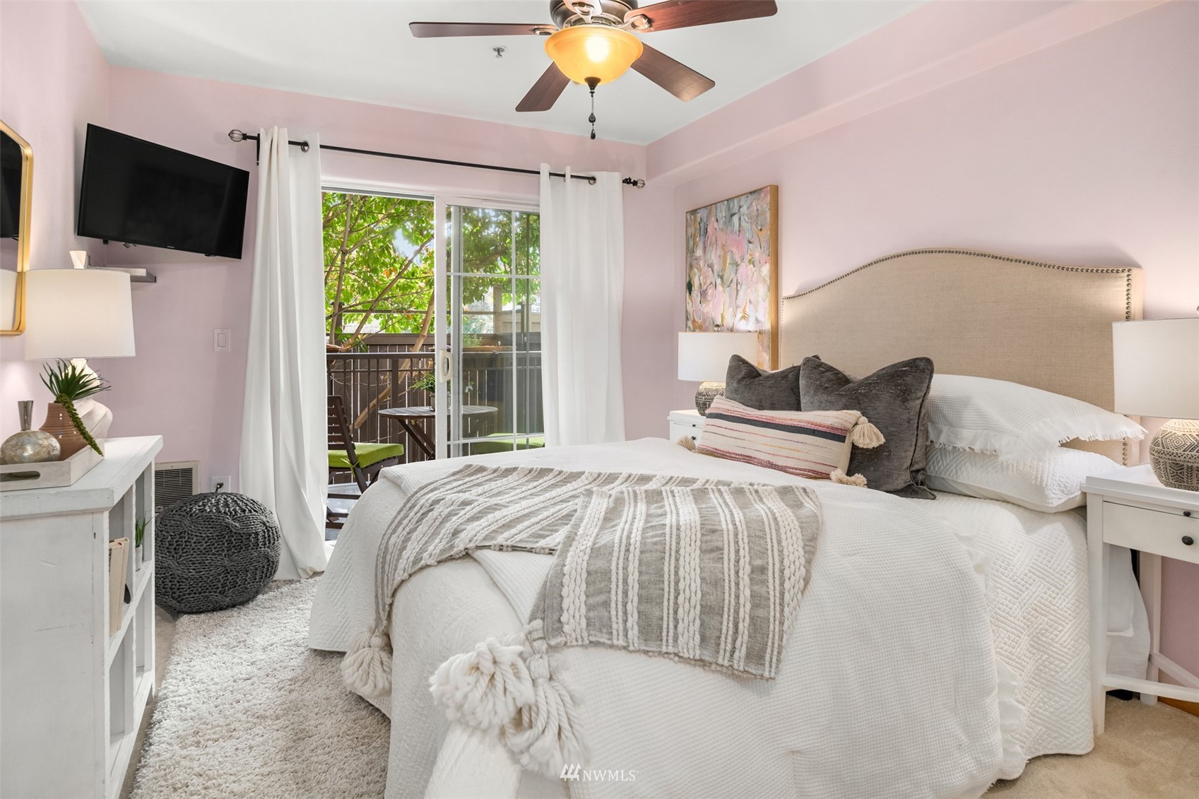 3015 Southwest Avalon Way, Unit 106 Seattle, WA 98126 - Photo 14 of 20 a bedroom with a bed and a chandelier