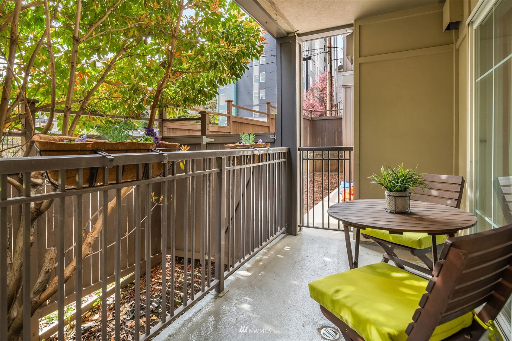 3015 Southwest Avalon Way, Unit 106 Seattle, WA 98126 - Photo 9 of 20 a view of a balcony with chairs and wooden fence