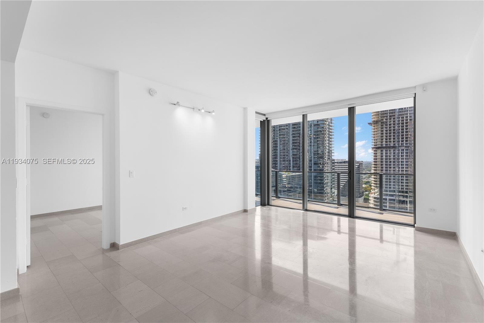 68 Southeast 6th Street, Unit 2006 Miami, FL 33131 - Photo 11 of 49 wooden floor in an empty room with a window
