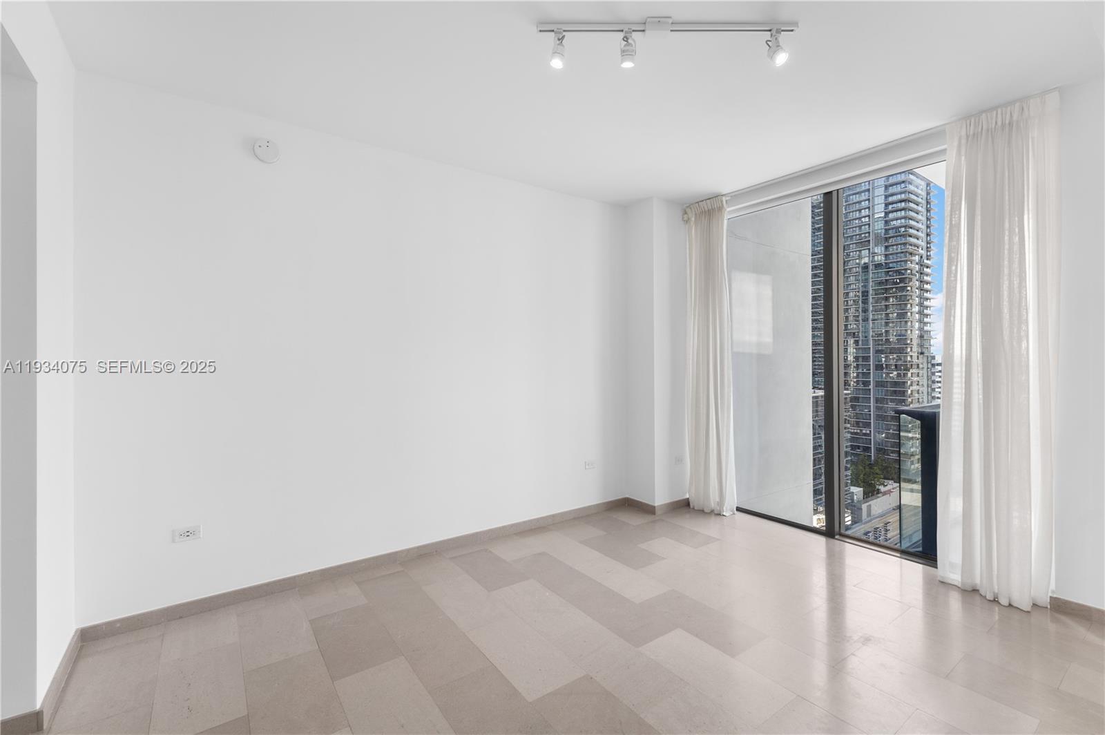 68 Southeast 6th Street, Unit 2006 Miami, FL 33131 - Photo 15 of 49 an empty room with windows