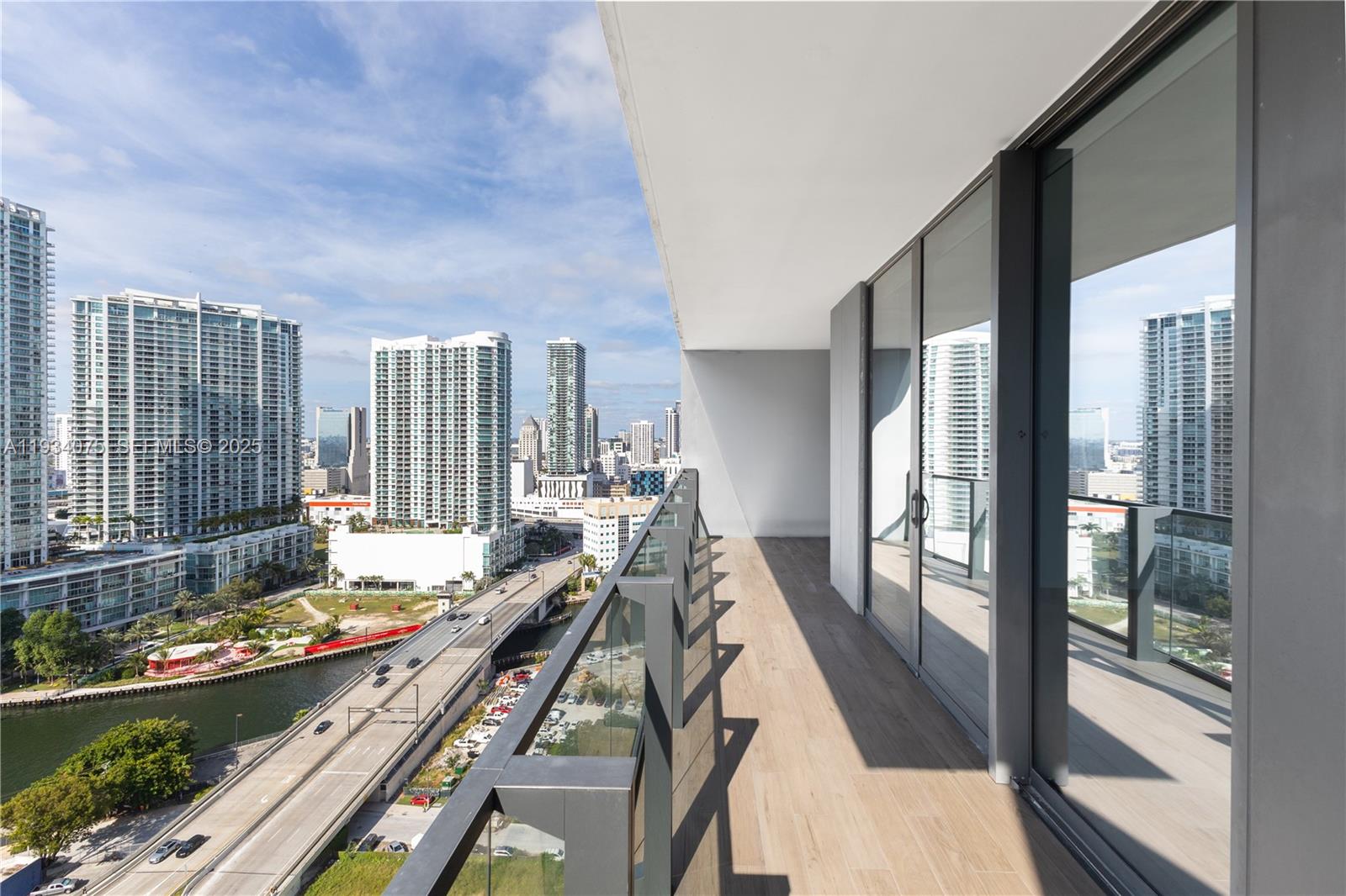 68 Southeast 6th Street, Unit 2006 Miami, FL 33131 - Photo 26 of 49 a very nice looking room with a large window and wooden floor