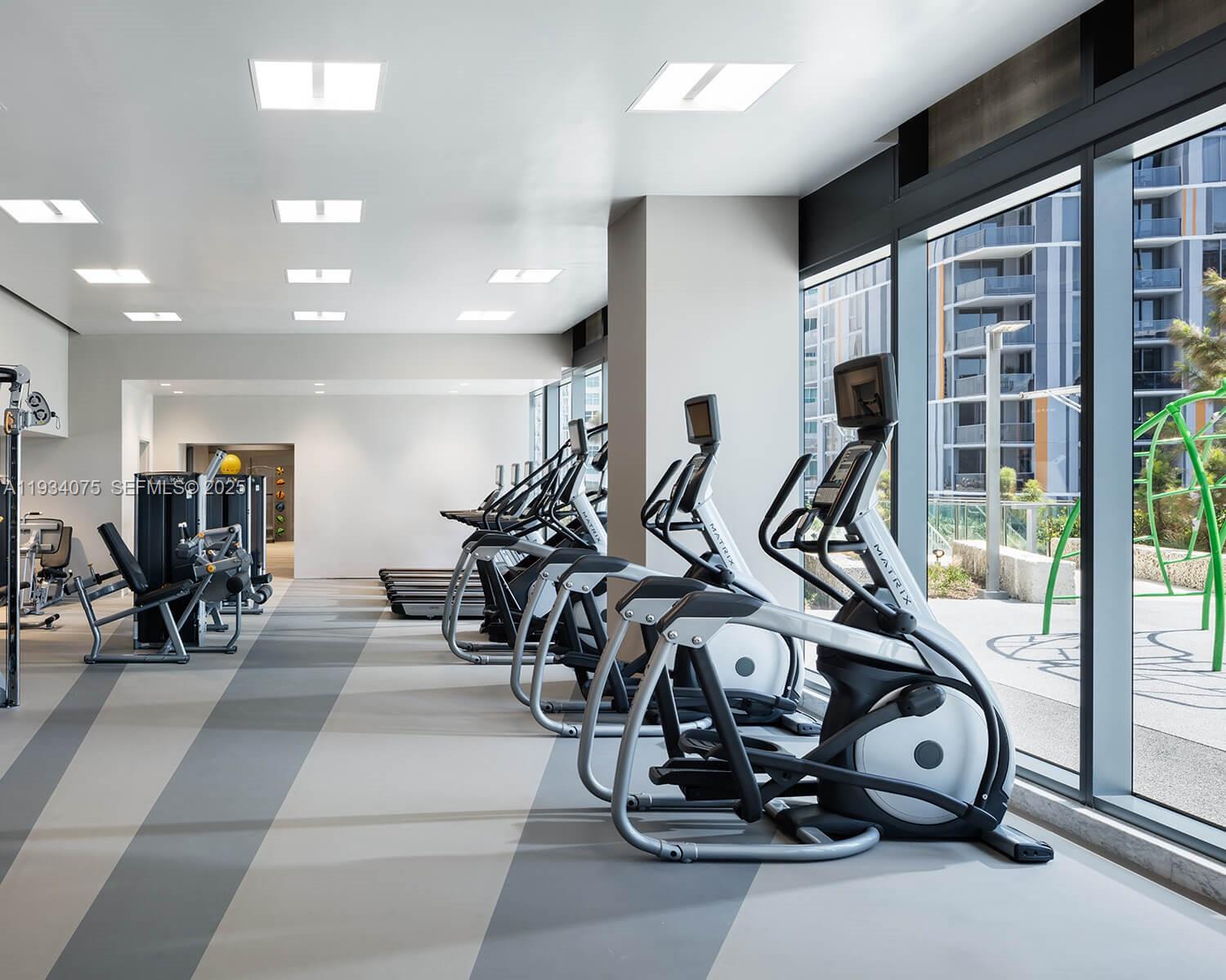 68 Southeast 6th Street, Unit 2006 Miami, FL 33131 - Photo 35 of 49 a view of a room with gym equipment