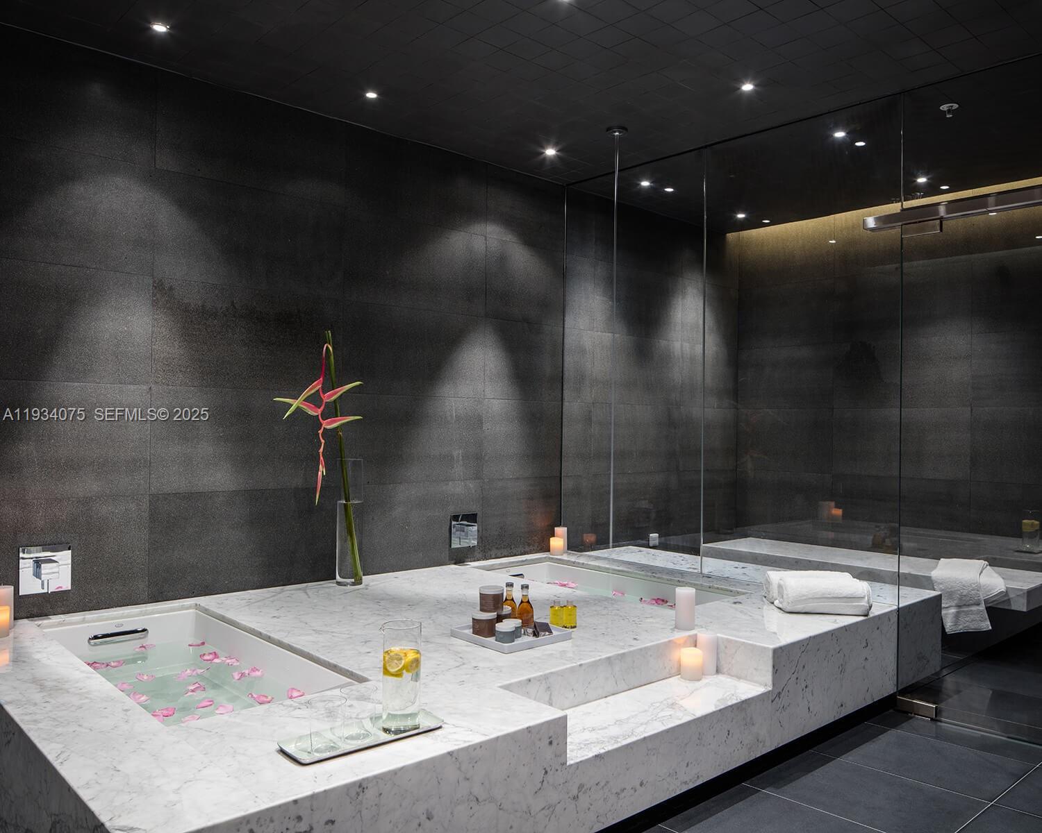 68 Southeast 6th Street, Unit 2006 Miami, FL 33131 - Photo 38 of 49 a bathroom with a sink and a mirror