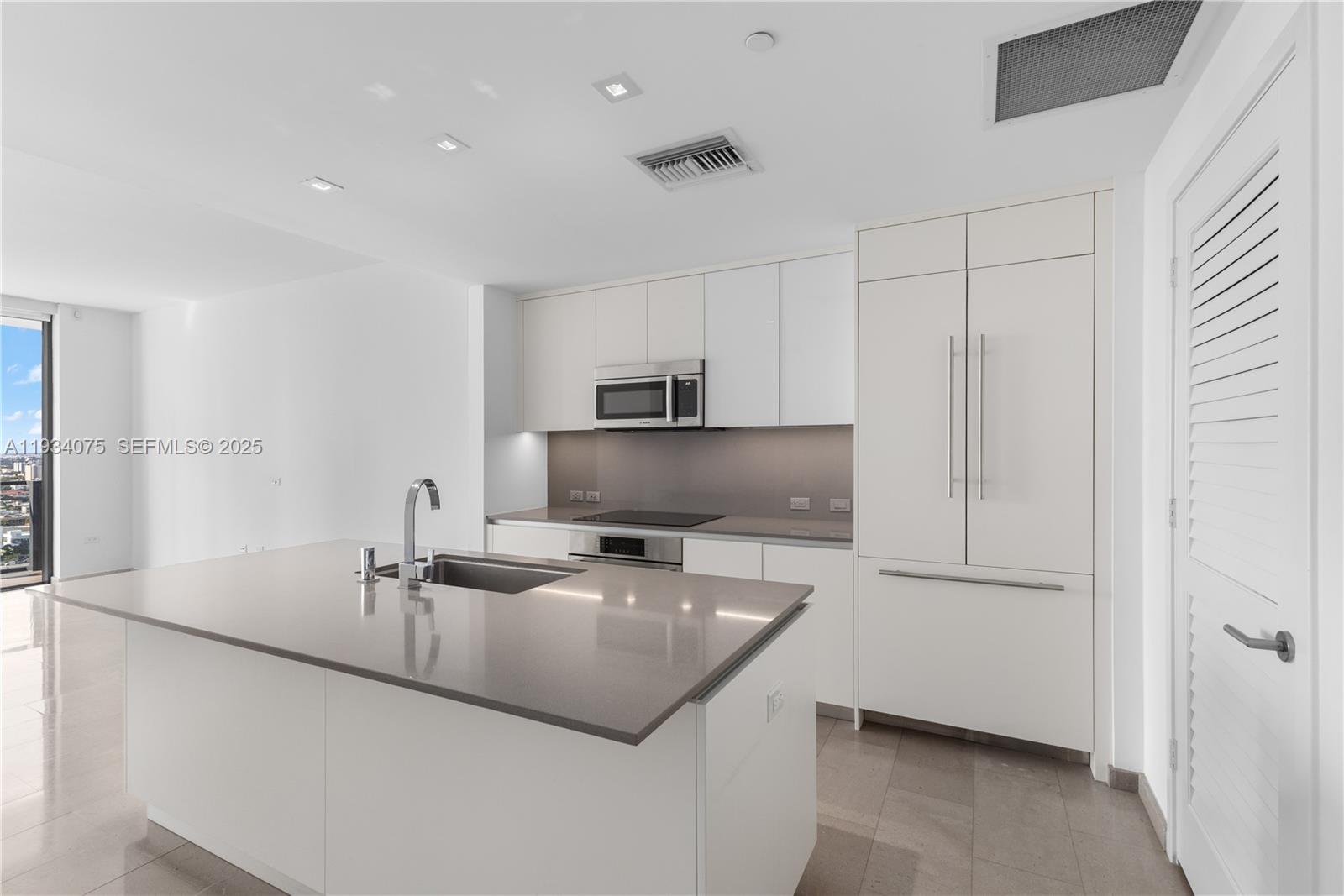 68 Southeast 6th Street, Unit 2006 Miami, FL 33131 - Photo 4 of 49 a kitchen with a sink appliances and cabinets