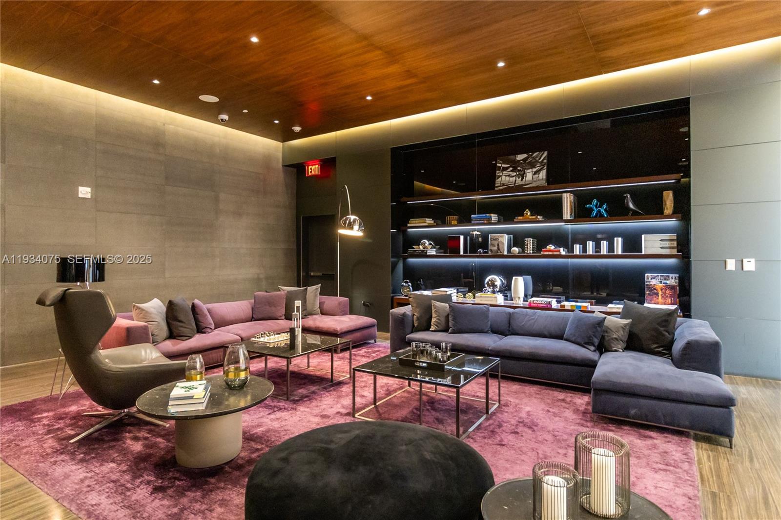 68 Southeast 6th Street, Unit 2006 Miami, FL 33131 - Photo 42 of 49 a living room with furniture a rug and a book shelf