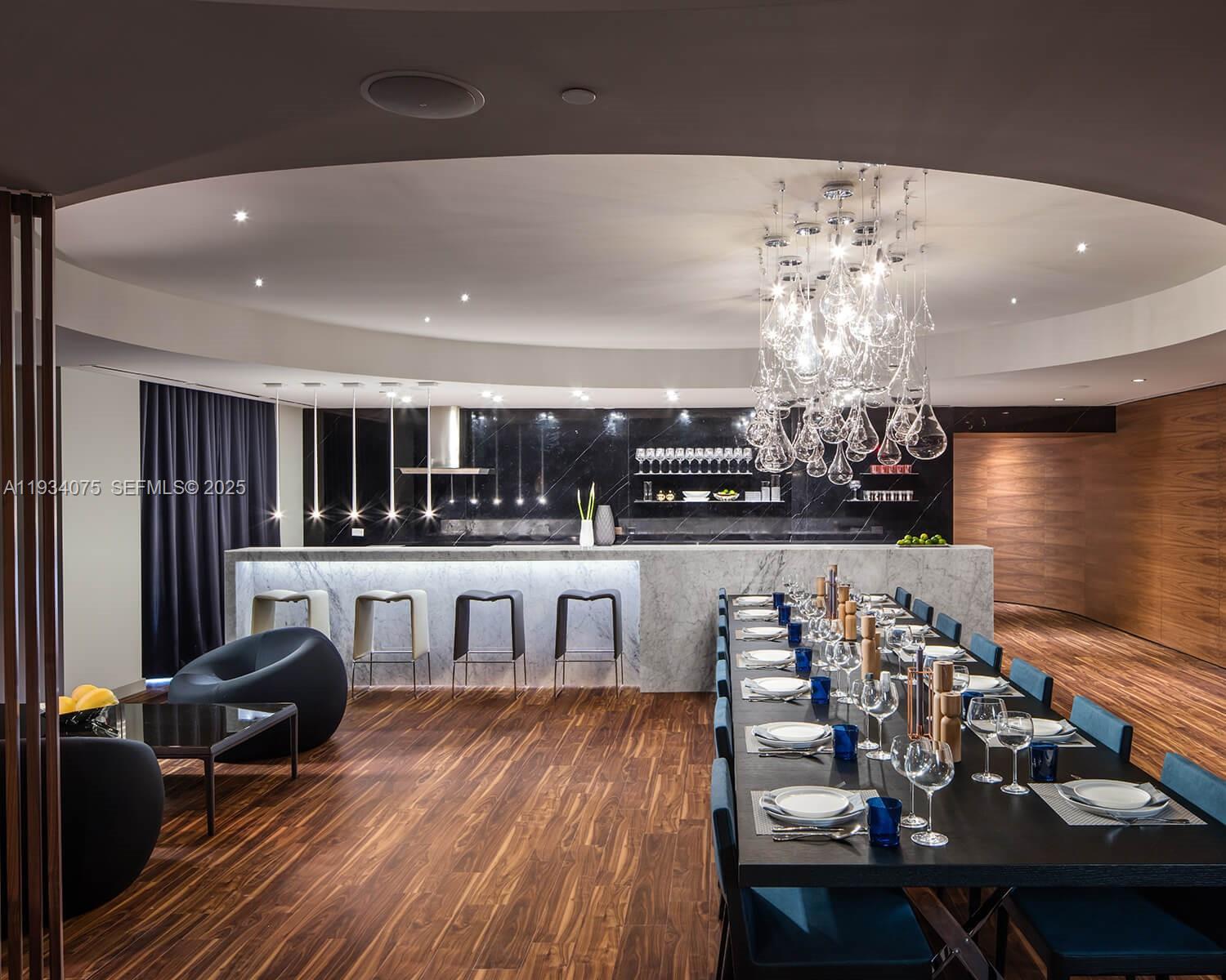 68 Southeast 6th Street, Unit 2006 Miami, FL 33131 - Photo 44 of 49 a view of a dining room with furniture a chandelier and wooden floor