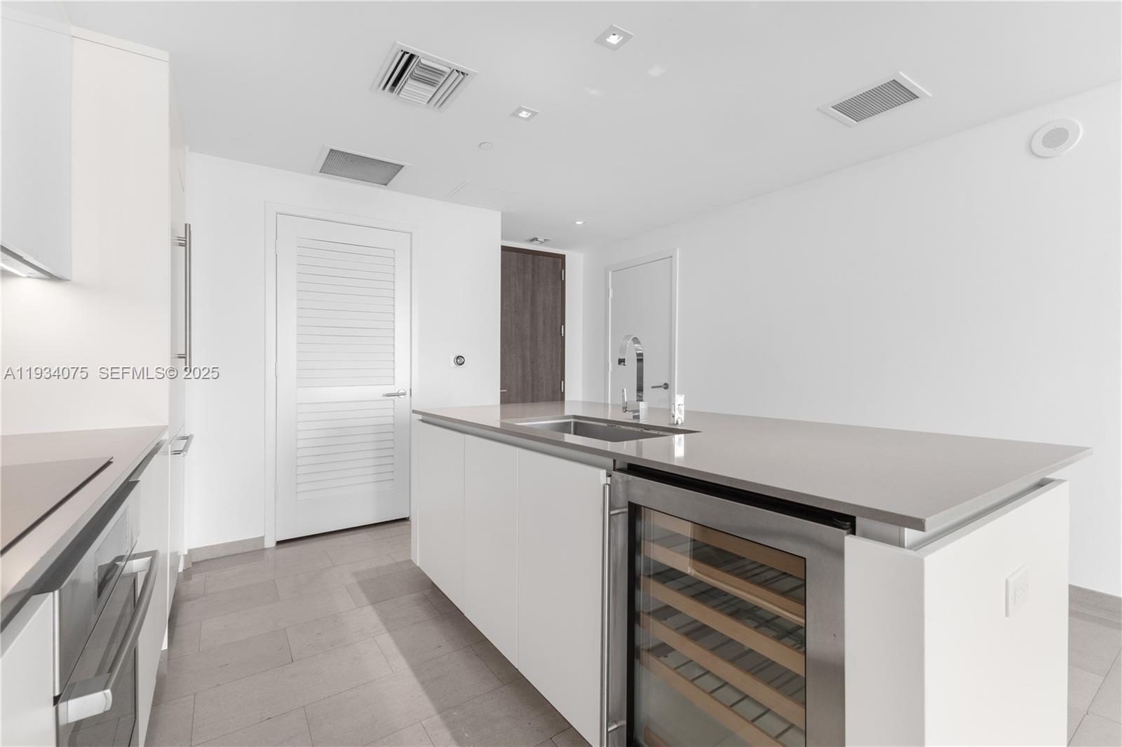 68 Southeast 6th Street, Unit 2006 Miami, FL 33131 - Photo 8 of 49 a kitchen with granite countertop a sink and cabinets