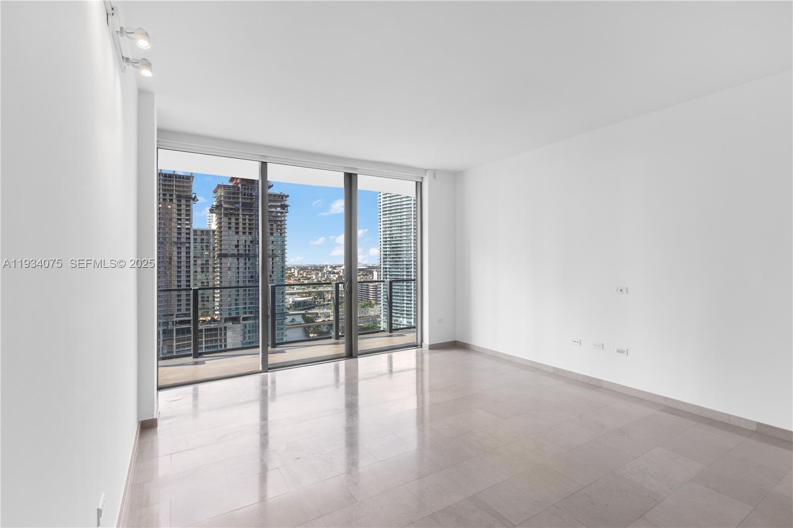 68 Southeast 6th Street, Unit 2006 Miami, FL 33131 - Photo 10 of 49 a view of an empty room with glass door