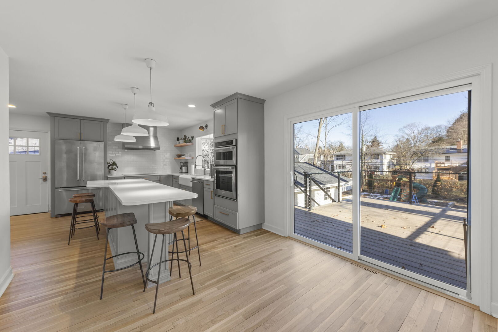 291 Spring Avenue Glen Ellyn, IL 60137 - Photo 11 of 35 a kitchen with stainless steel appliances wooden floor and a large window
