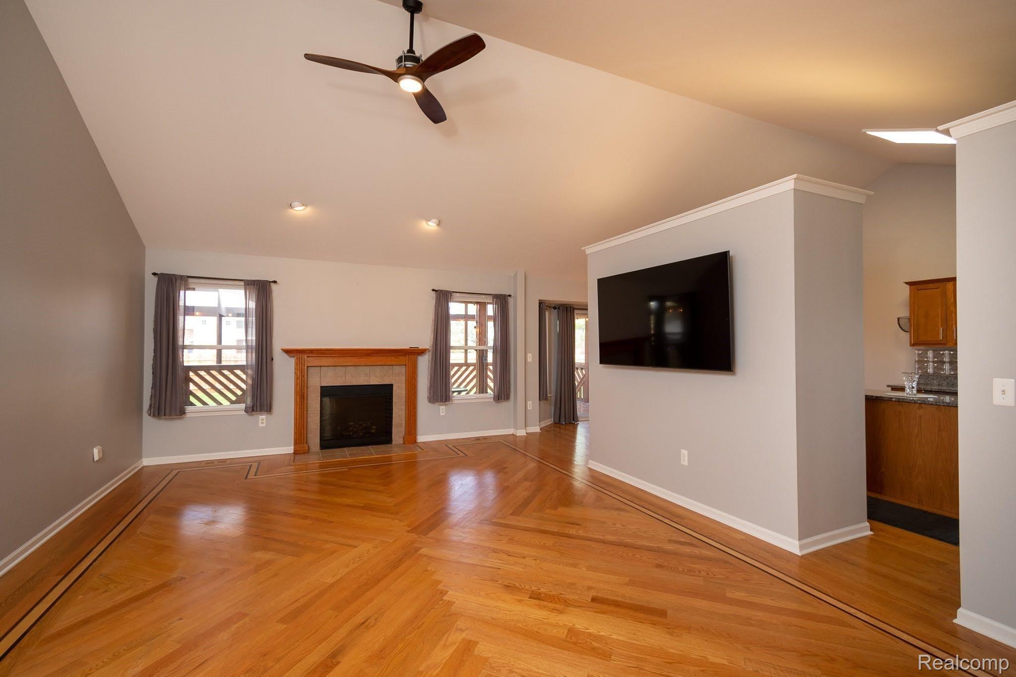 2457 Durham Road Utica, MI 48317 - Photo 10 of 27 Huge living room with electric fireplace, vaulted ceilings, ceiling fans,