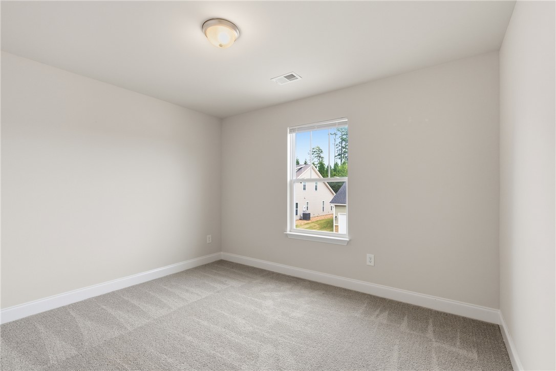 116 Ventura Street Anderson, SC 29621 - Photo 19 of 27 Soft carpeting pairs with a central window in this versatile bedroom.