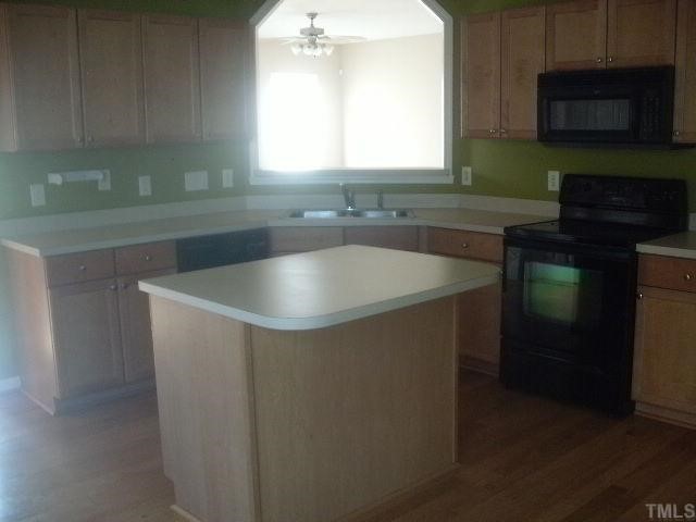 3975 Cane Garden Drive Raleigh, NC 27610 - Photo 3 of 7 Eat -in- Kitchen w/island & hardwood floors