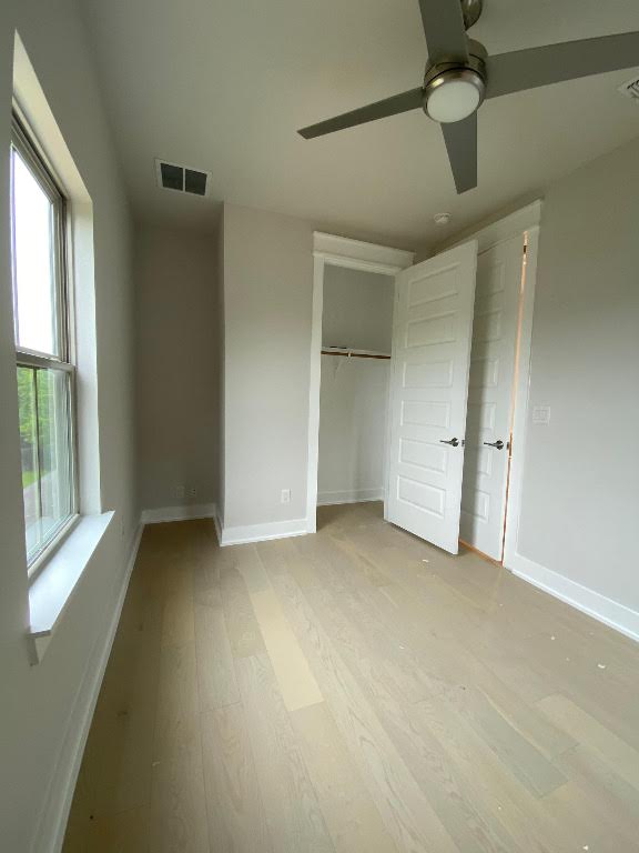 6920 Bethune Avenue, Unit 3 Austin, TX 78752 - Photo 12 of 32 Unfurnished bedroom with a closet, light wood-style floors, and ceiling fan