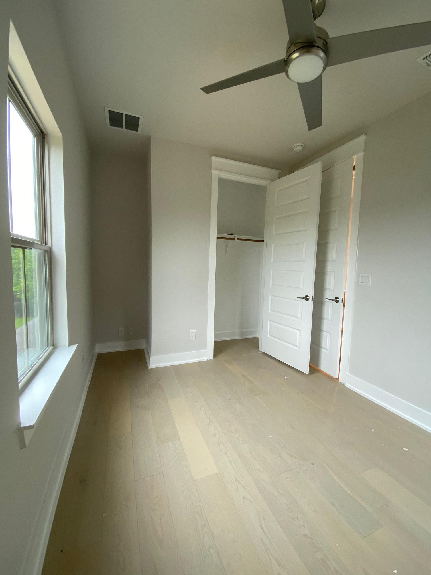 6920 Bethune Avenue, Unit 3 Austin, TX 78752 - Photo 12 of 32 Unfurnished bedroom with a closet, light wood-style floors, and ceiling fan