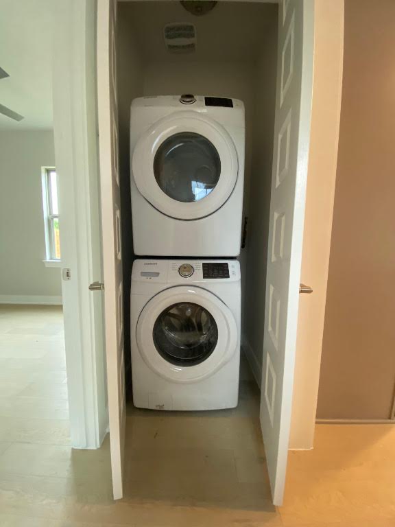 6920 Bethune Avenue, Unit 3 Austin, TX 78752 - Photo 26 of 32 Laundry room featuring stacked washer / drying machine