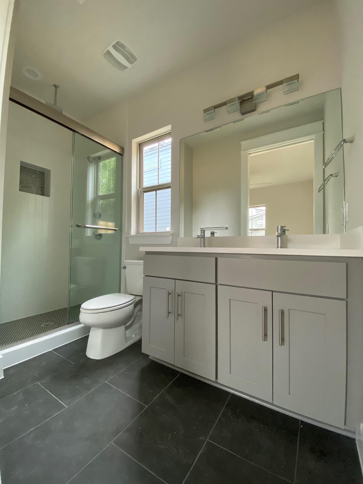 6920 Bethune Avenue, Unit 3 Austin, TX 78752 - Photo 27 of 32 Full bath featuring double vanity, a shower stall, and dark tile patterned flooring