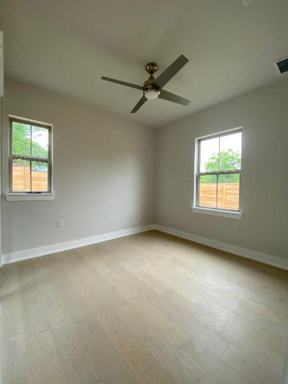 6920 Bethune Avenue, Unit 3 Austin, TX 78752 - Photo 3 of 32 Spare room featuring light wood-type flooring and ceiling fan