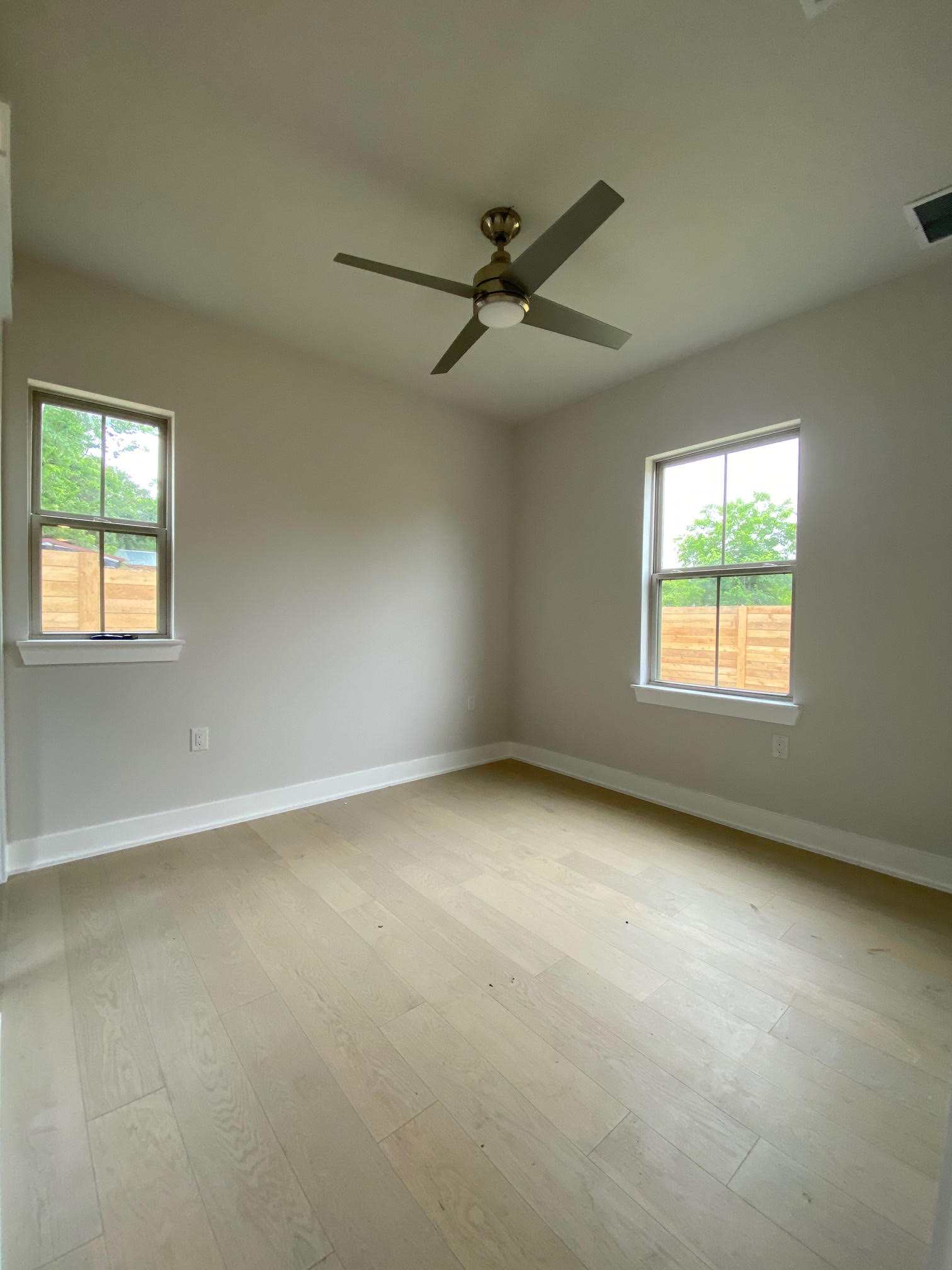 6920 Bethune Avenue, Unit 3 Austin, TX 78752 - Photo 3 of 32 Spare room featuring light wood-type flooring and ceiling fan