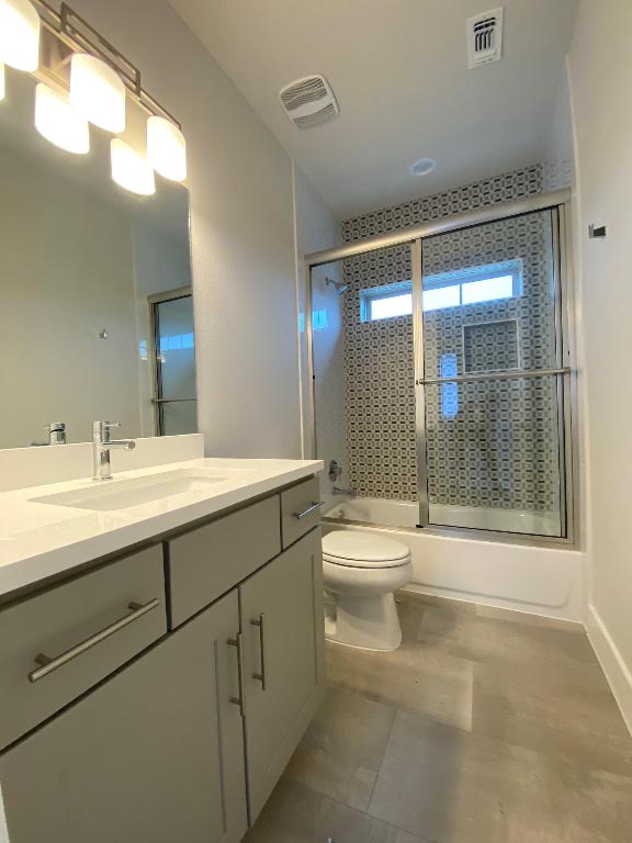 6920 Bethune Avenue, Unit 3 Austin, TX 78752 - Photo 30 of 32 Bathroom with vanity and bath / shower combo with glass door