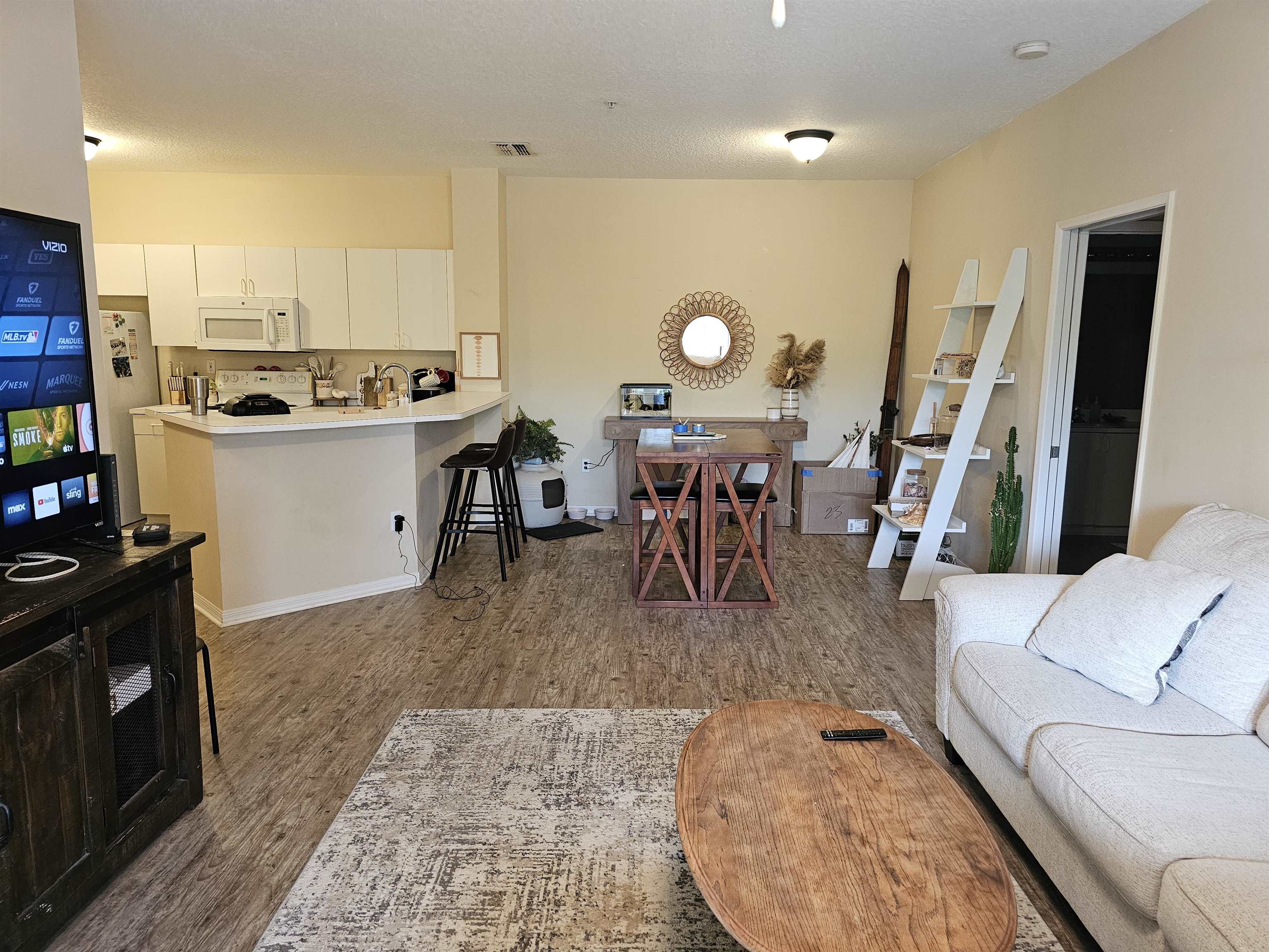 605 Fairway Drive, Unit 307 St. Augustine, FL 32084 - Photo 1 of 16 a living room with couches a coffee table and kitchen view with wooden floor