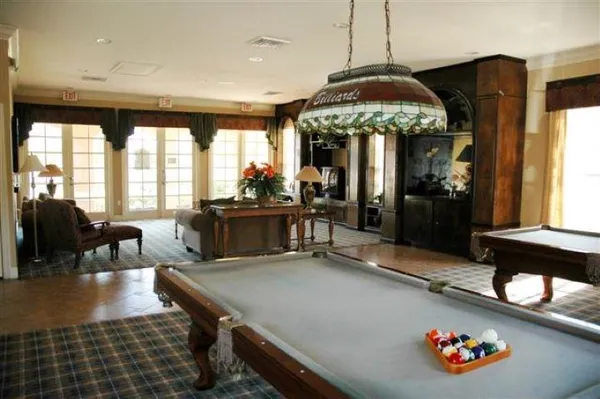 a dining room with furniture and large windows