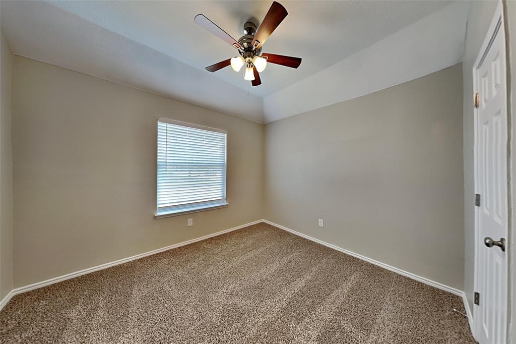 1202 Dove Brook Drive Allen, TX 75002 - Photo 16 of 23 Unfurnished room featuring carpet flooring, lofted ceiling, and a ceiling fan