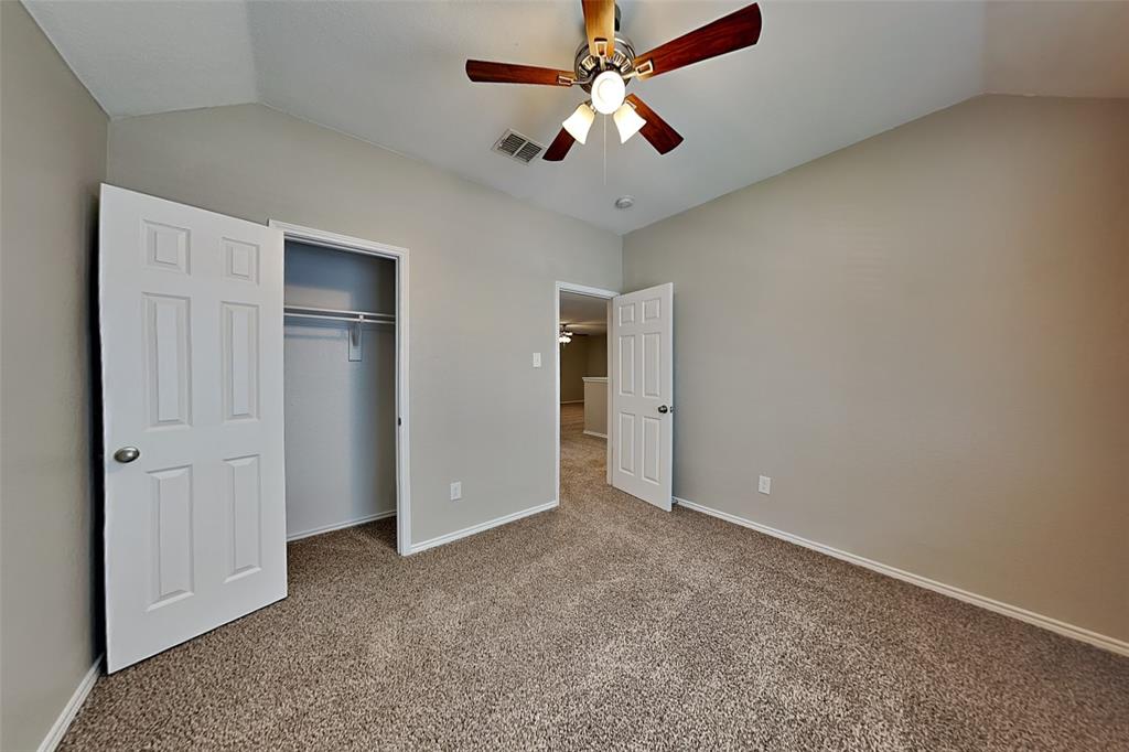 1202 Dove Brook Drive Allen, TX 75002 - Photo 17 of 23 Unfurnished bedroom featuring lofted ceiling, carpet flooring, ceiling fan, and a closet