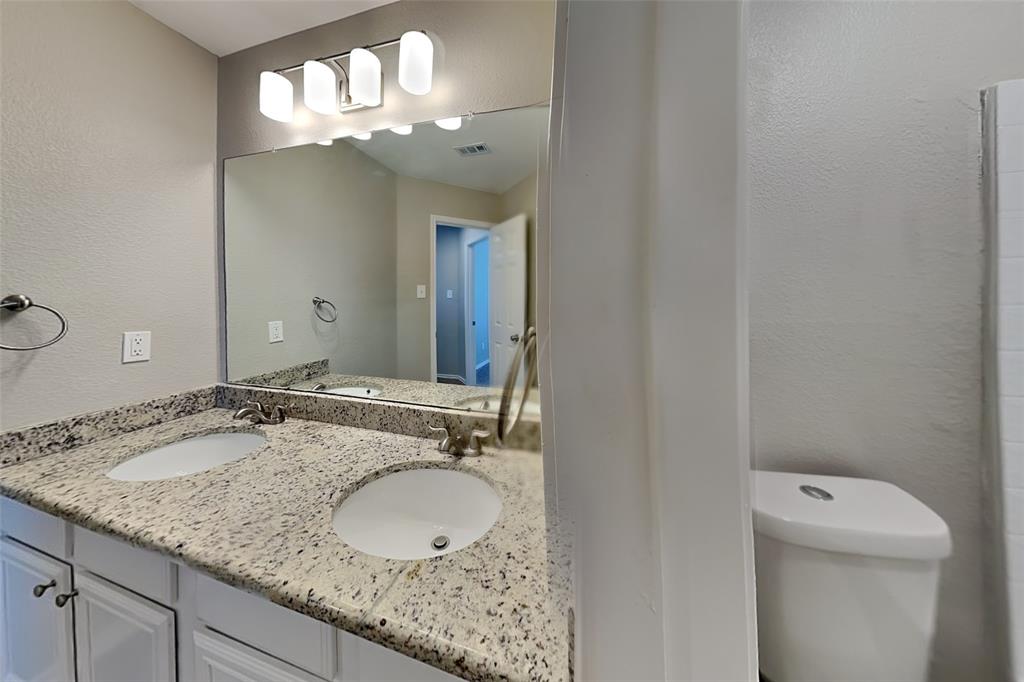 1202 Dove Brook Drive Allen, TX 75002 - Photo 18 of 23 Bathroom with a textured wall and double vanity
