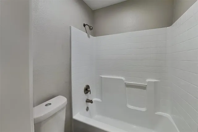 a bathroom with a bathtub and toilet