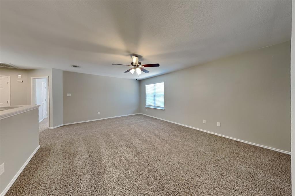1202 Dove Brook Drive Allen, TX 75002 - Photo 20 of 23 Empty room featuring light colored carpet and a ceiling fan