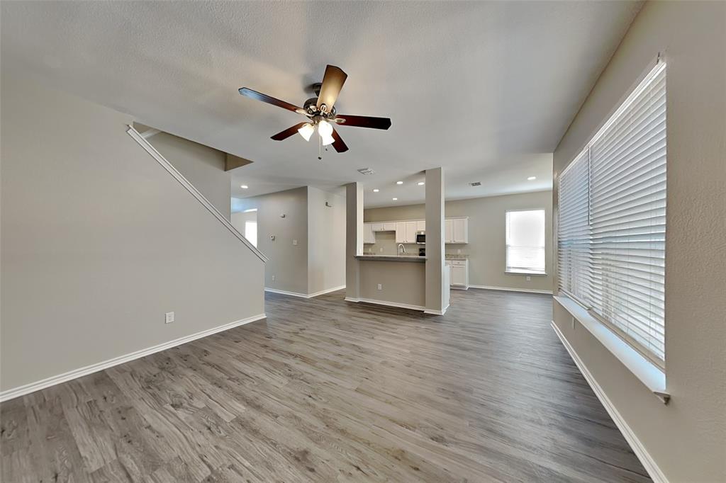 1202 Dove Brook Drive Allen, TX 75002 - Photo 2 of 23 Unfurnished living room with dark wood-style flooring, a ceiling fan, and recessed lighting