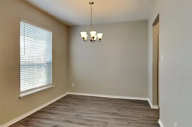 a view of a chandelier in big room and chandelier fan