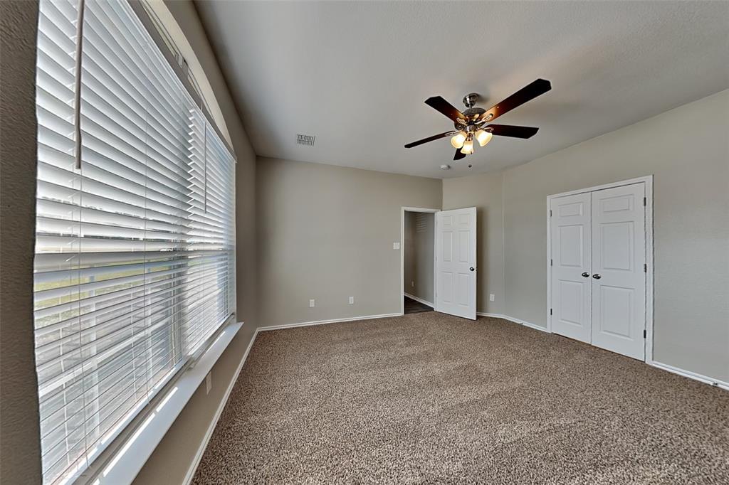 1202 Dove Brook Drive Allen, TX 75002 - Photo 7 of 23 Unfurnished bedroom featuring carpet, a ceiling fan, and a closet