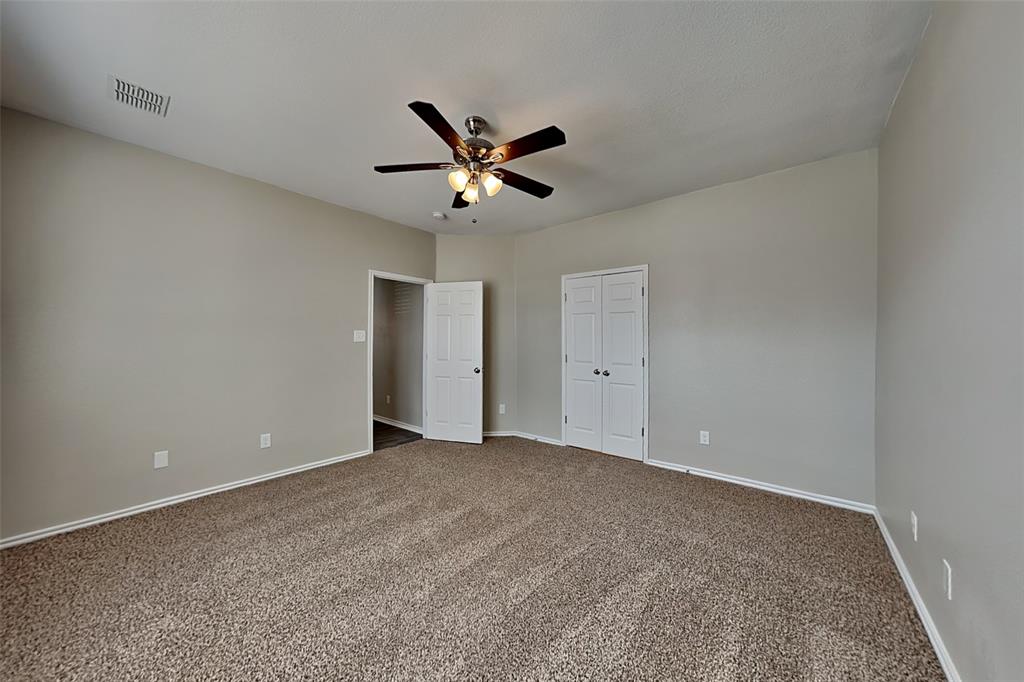 1202 Dove Brook Drive Allen, TX 75002 - Photo 8 of 23 Unfurnished bedroom featuring carpet floors, a ceiling fan, and a closet