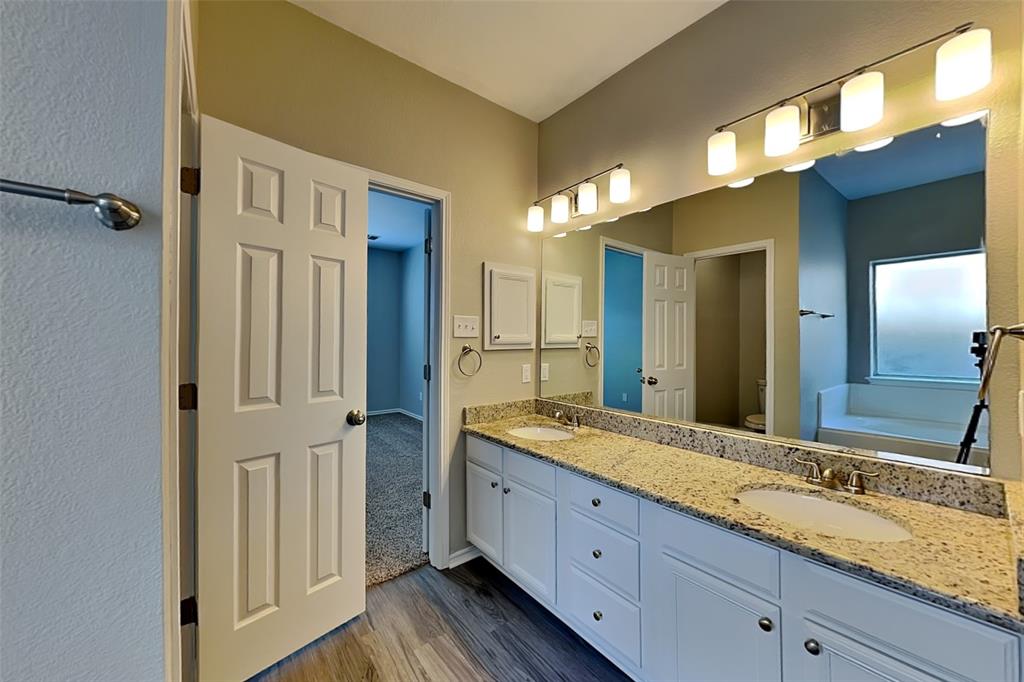 1202 Dove Brook Drive Allen, TX 75002 - Photo 9 of 23 Bathroom with a bath, dark wood-style floors, and double vanity