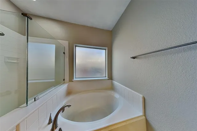 a bathroom with a bathtub and shower