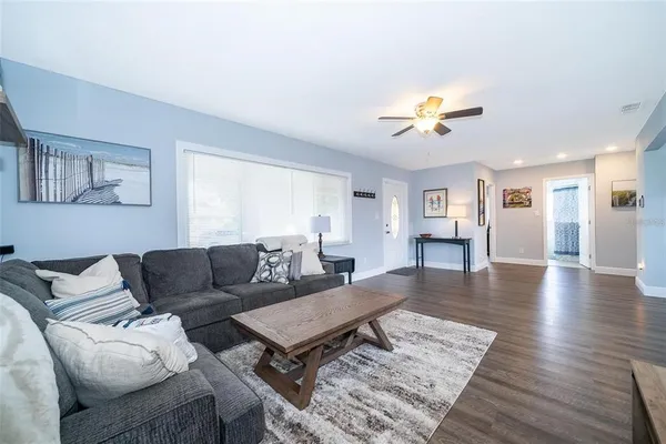 a living room with furniture and wooden floor