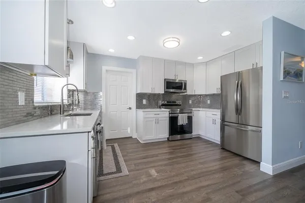 a kitchen with a refrigerator a sink and a stove