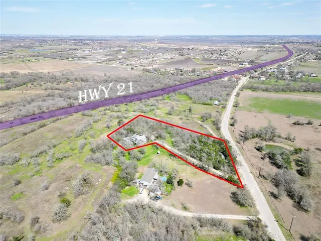an aerial view of beach and residential houses with outdoor space