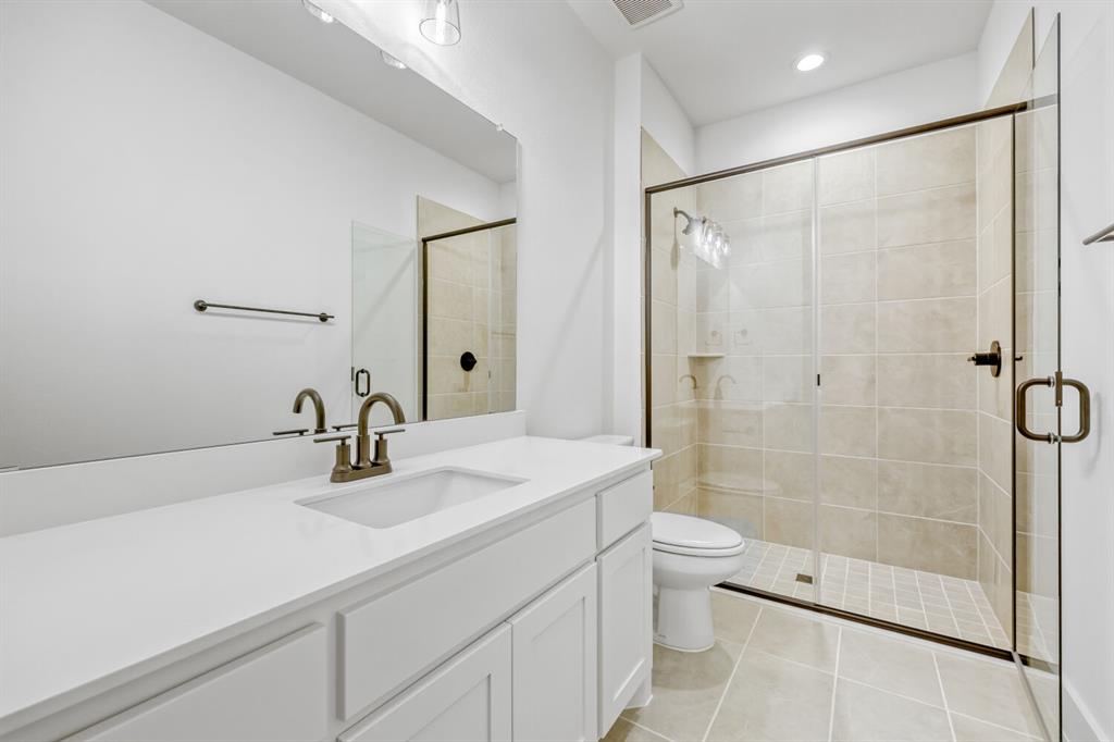 147 Derrett Lane Rhome, TX 76078 - Photo 18 of 28 Bathroom featuring vanity, a stall shower, light tile patterned floors, and recessed lighting