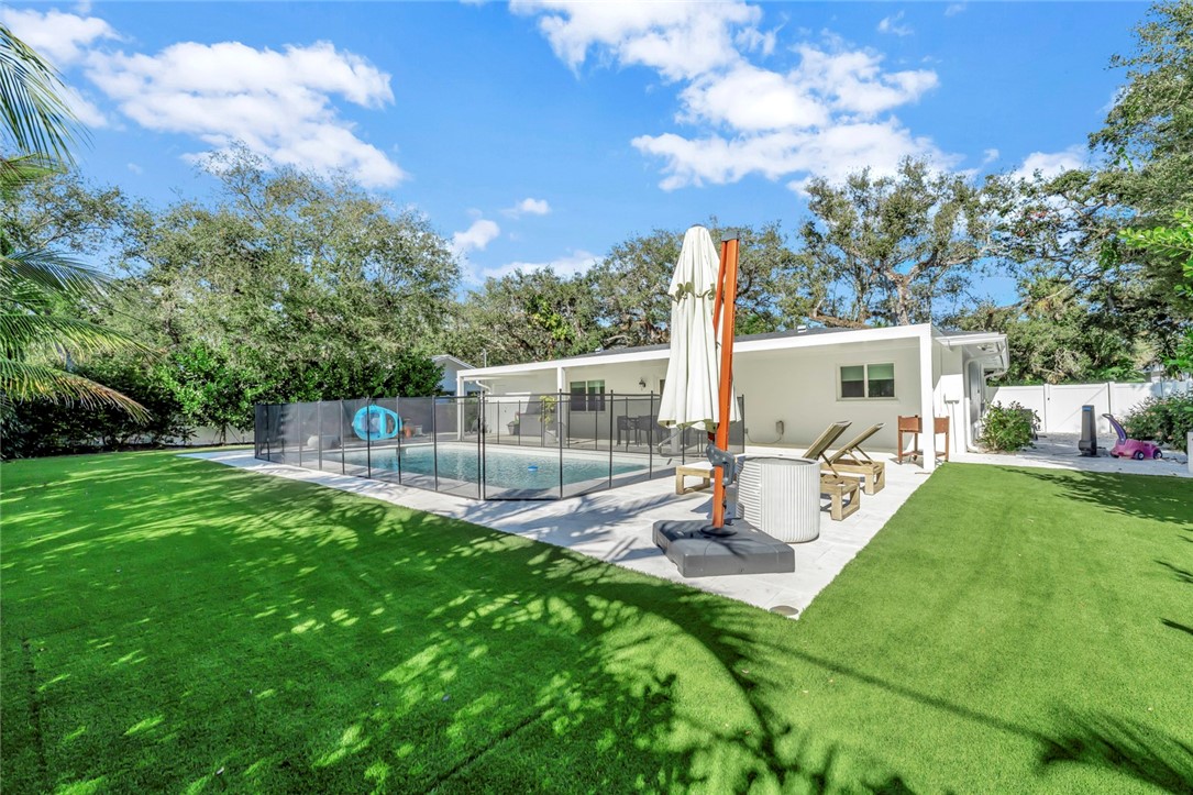 a view of a backyard with sitting area