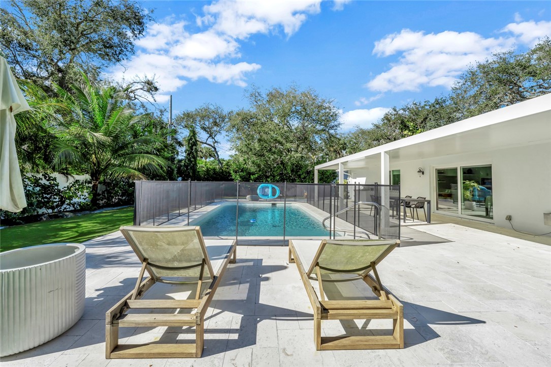 406 Indian Lilac Road Vero Beach, FL 32963 - Photo 12 of 36 a view of a chair and table in backyard of the house