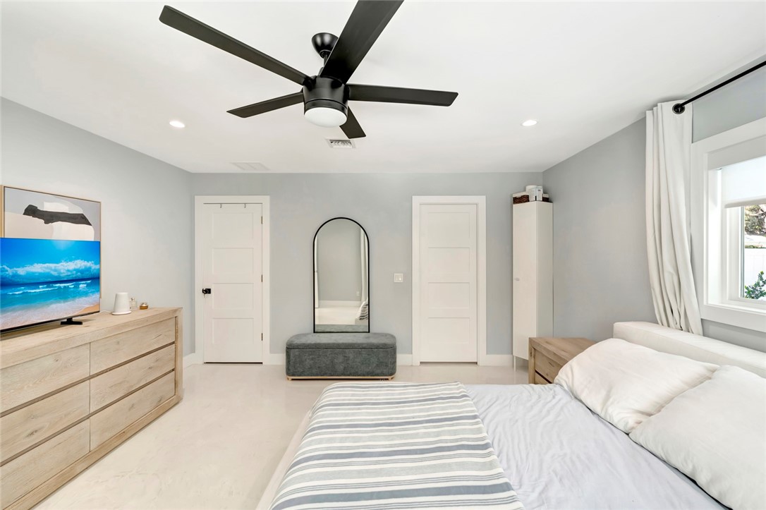 406 Indian Lilac Road Vero Beach, FL 32963 - Photo 18 of 36 a bedroom with a bed and a flat screen tv