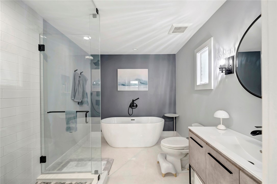 406 Indian Lilac Road Vero Beach, FL 32963 - Photo 21 of 36 a bathroom with a toilet sink and mirror