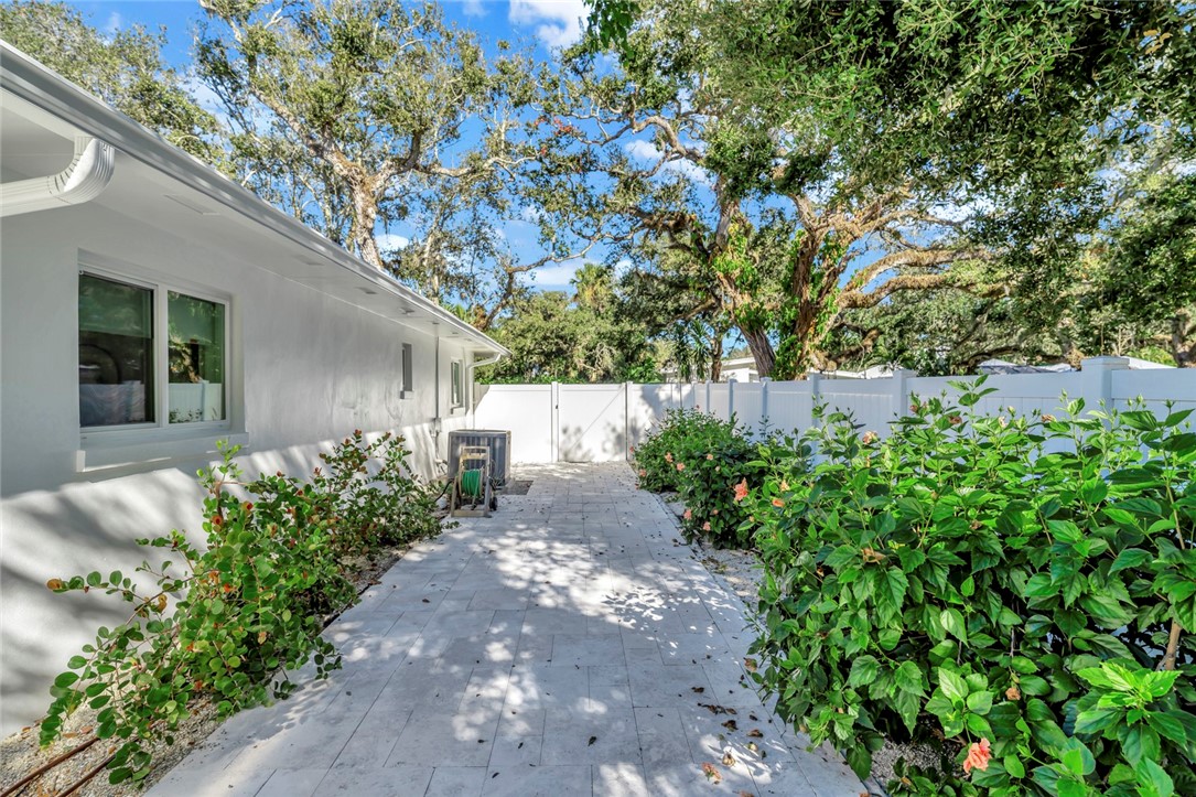 406 Indian Lilac Road Vero Beach, FL 32963 - Photo 26 of 36 a view of a pathway with a flower garden