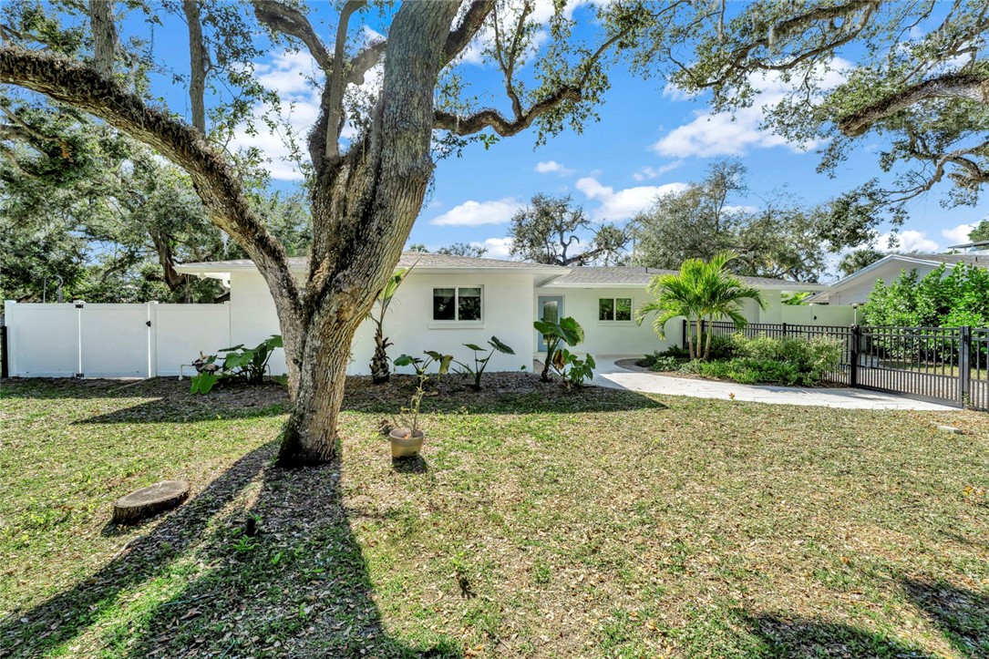 406 Indian Lilac Road Vero Beach, FL 32963 - Photo 30 of 36 a view of a house with backyard and sitting area