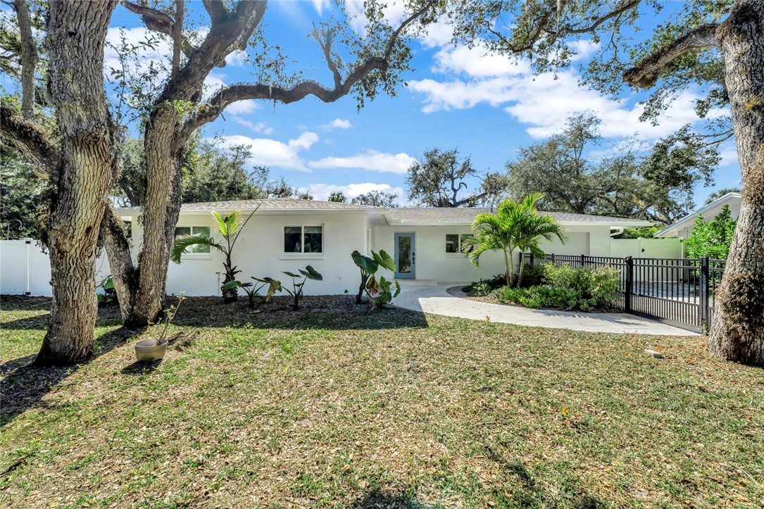 406 Indian Lilac Road Vero Beach, FL 32963 - Photo 3 of 36 a view of a house with backyard and sitting area