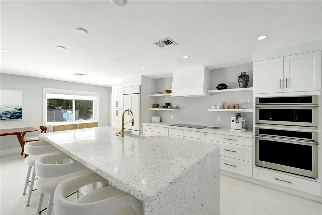 406 Indian Lilac Road Vero Beach, FL 32963 - Photo 6 of 36 a kitchen with stainless steel appliances granite countertop a stove and a sink