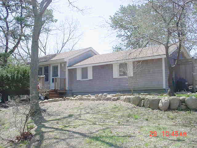 260 The Boulevard Edgartown, MA 02539 - Photo 2 of 8 a backyard of a house with table and chairs