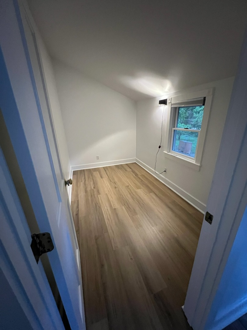 260 The Boulevard Edgartown, MA 02539 - Photo 7 of 8 a view of an empty room with wooden floor and a window